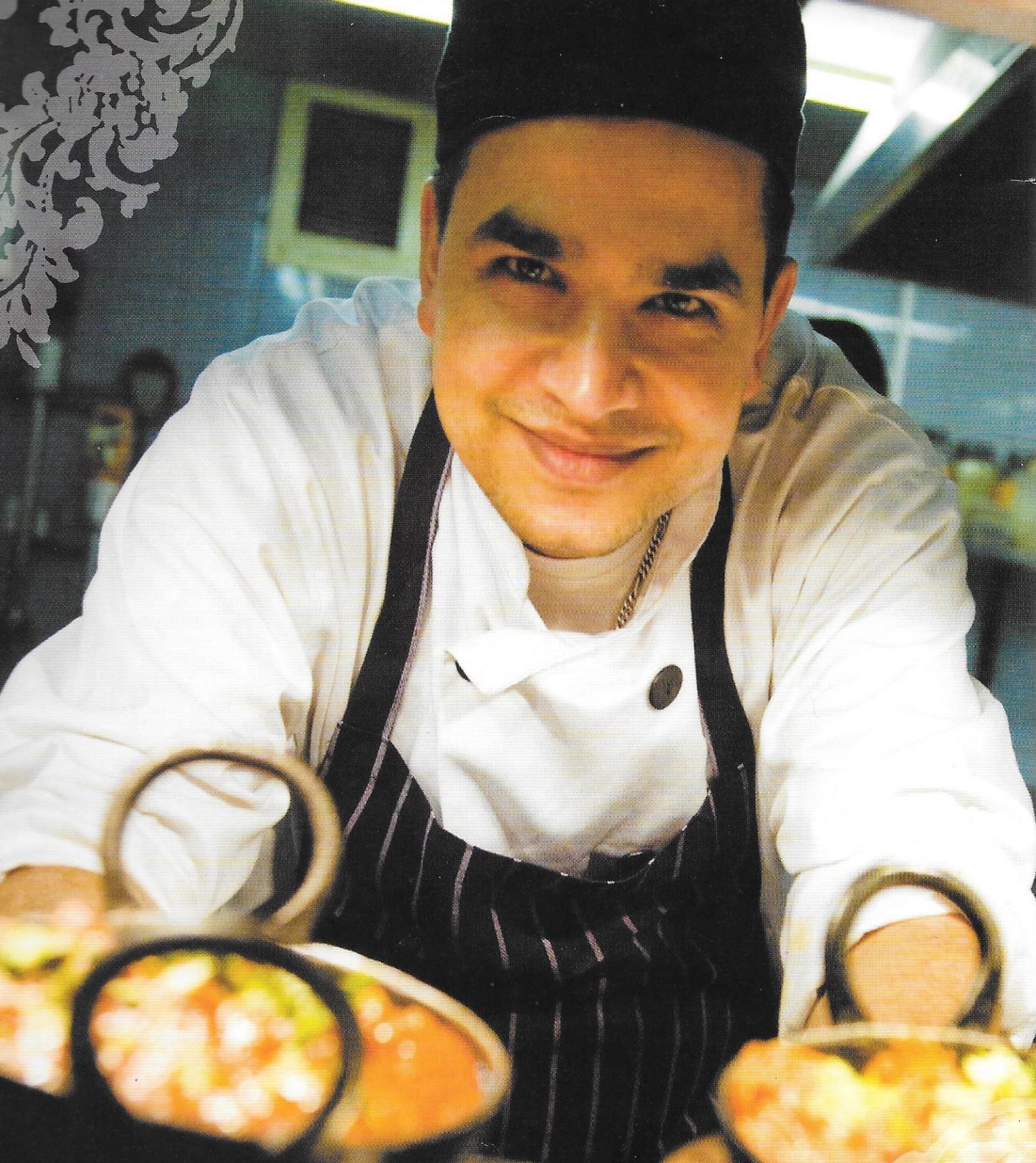 Chef Kul of Saffron Indian & Hakka Cuisine presenting dishes in the kitchen