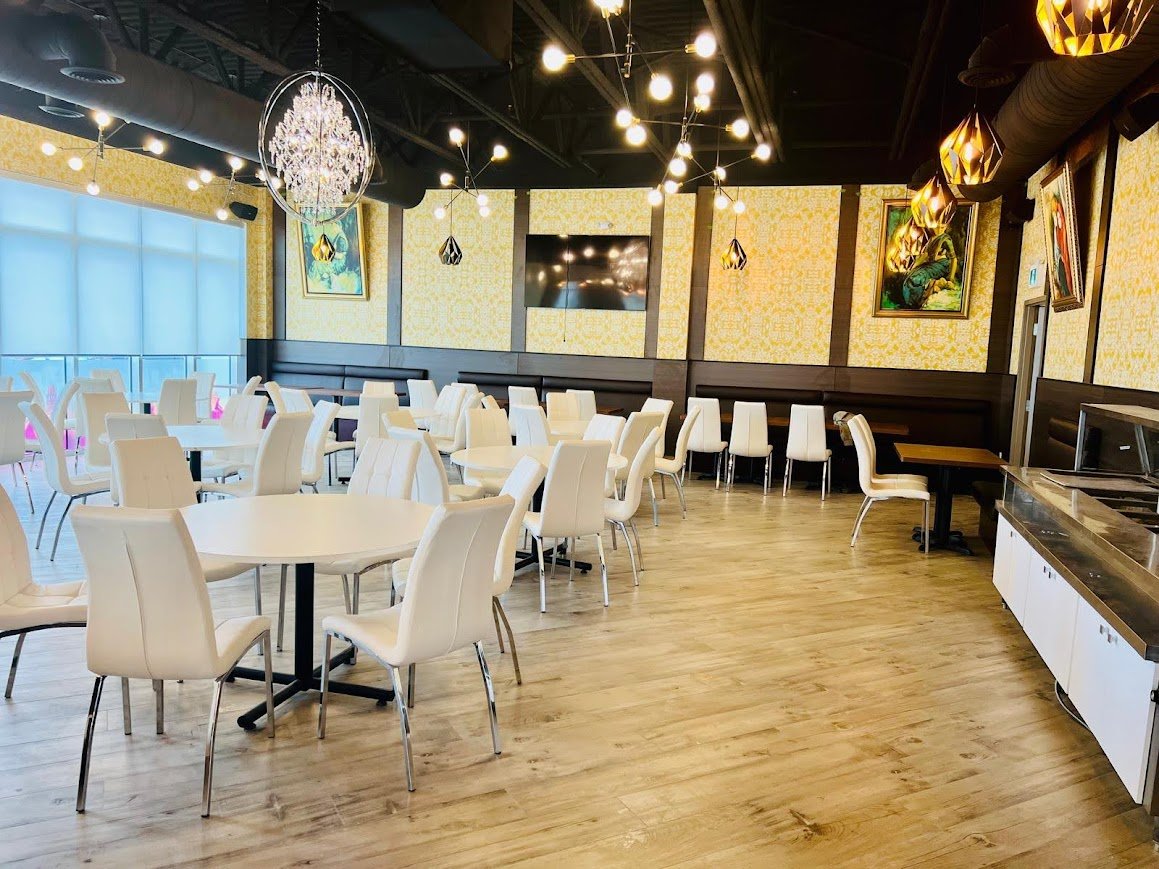 Dining room at Saffron with round tables and banquette seating